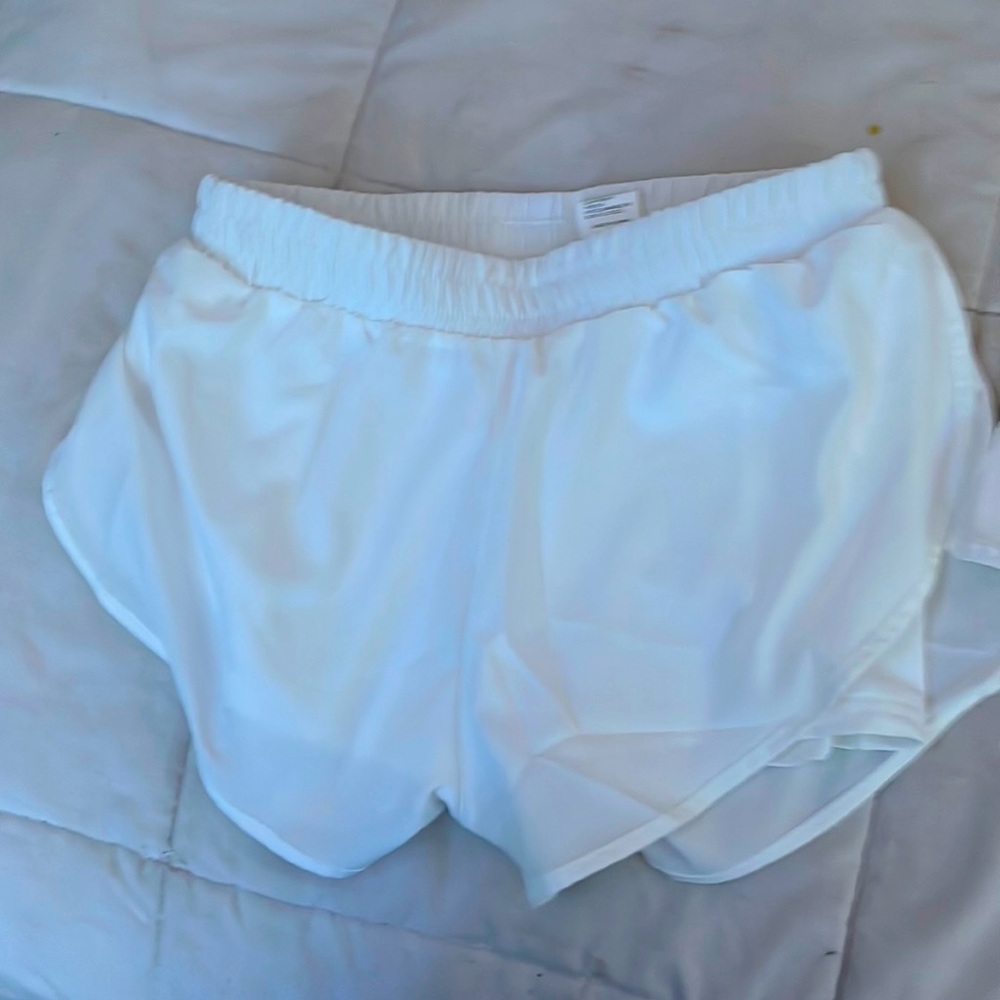 selling comfy shorts white and has shorts in the inside with a pocket